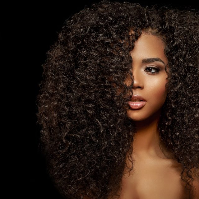 Beauty Fashion model. Black woman face & beautiful voluminous ha