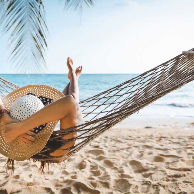 Traveler asian woman relax in hammock on summer beach Thailand